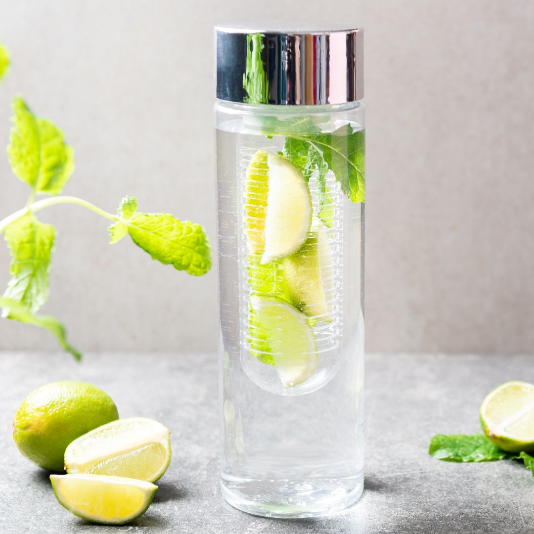 water bottle filled with limes in a diffuser water bottle filled with limes in a diffuser